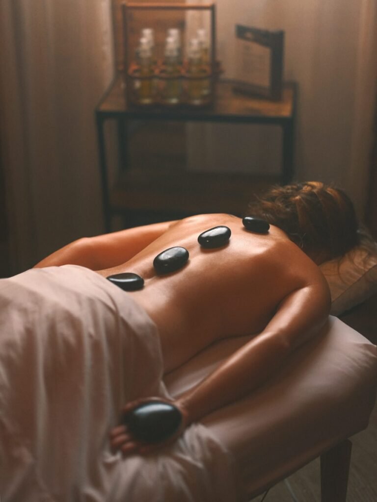 Hot stone massage with warmed basalt stones on the back
